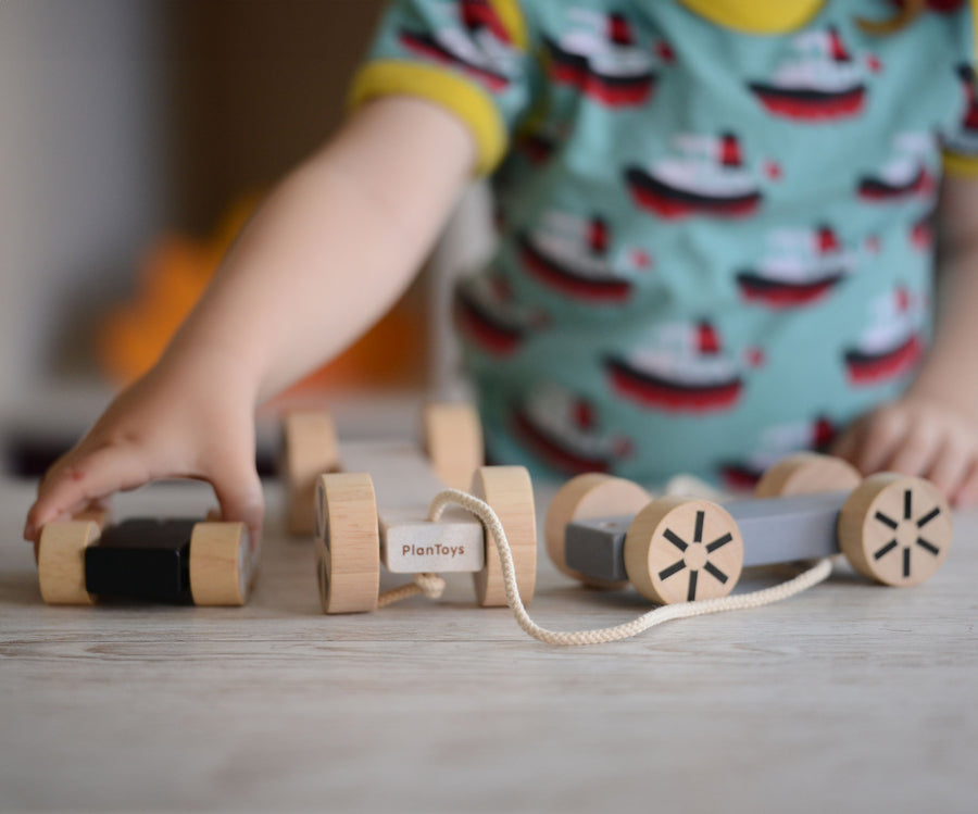 A child playing with the Plan Toys Stacking Wheels. 