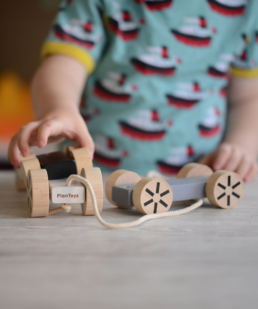 A child playing with the Plan Toys Stacking Wheels. 