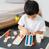 A child playing with the PlanToys 10 Frame Number Game.