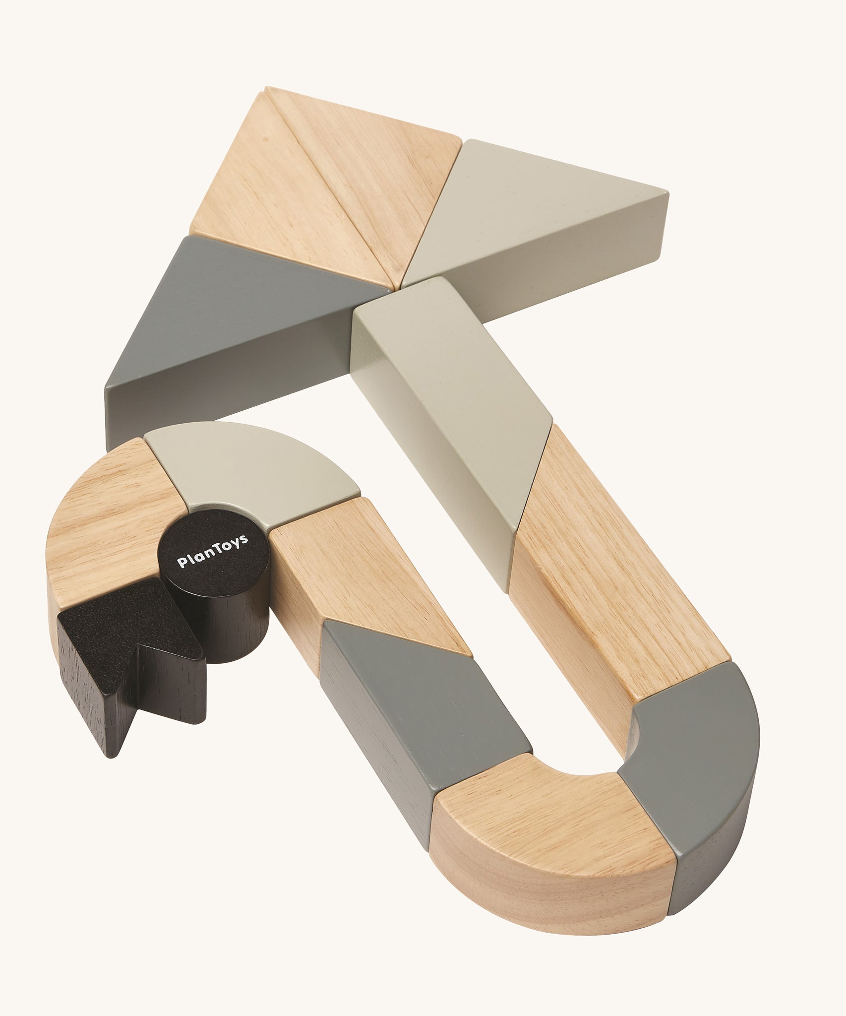 The PlanToys Twisted Blocks laid out to create an arrow shape on a plain background. 