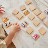 Young boy moving pieces of PlanToys animal blocks guessing game on a white marble table.