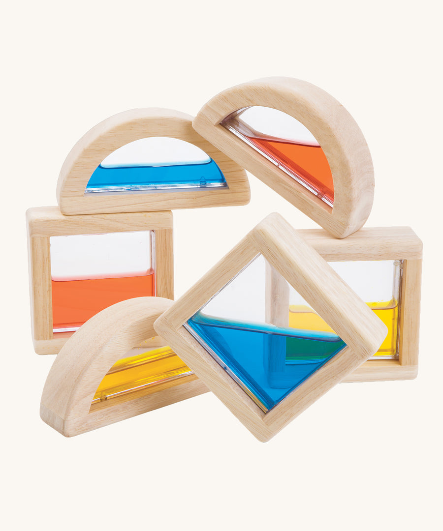 PlanToys wooden sensory Water Blocks on a plain background. The blocks are pictured out of their packaging. 
