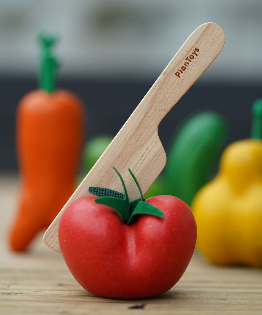 The wooden knife from the shown half way through the tomato.