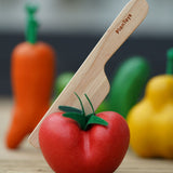 The wooden knife from the shown half way through the tomato.