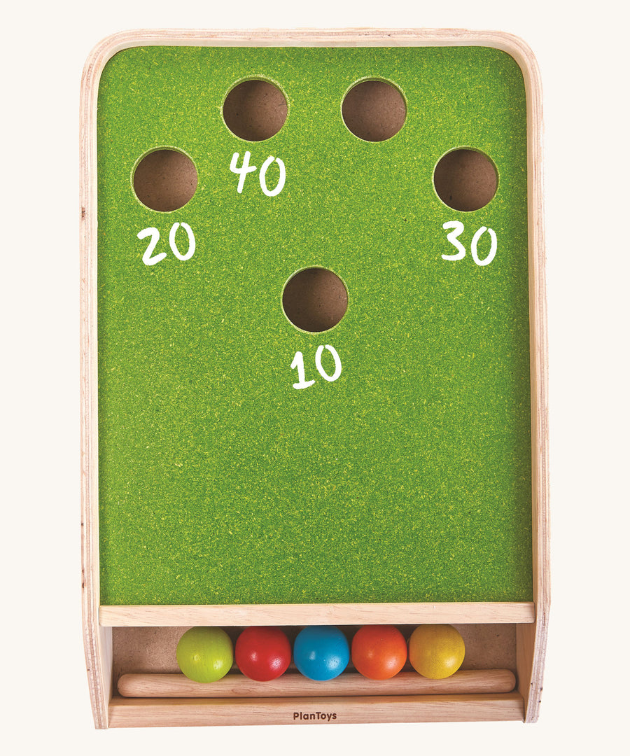 An overhead view of the PlanToys Ball Shoot Board Game on a plain background. Chalk has been used to write score numbers near the holes. 