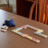 The PlanToys wooden mood dominos game set up on a wooden table.