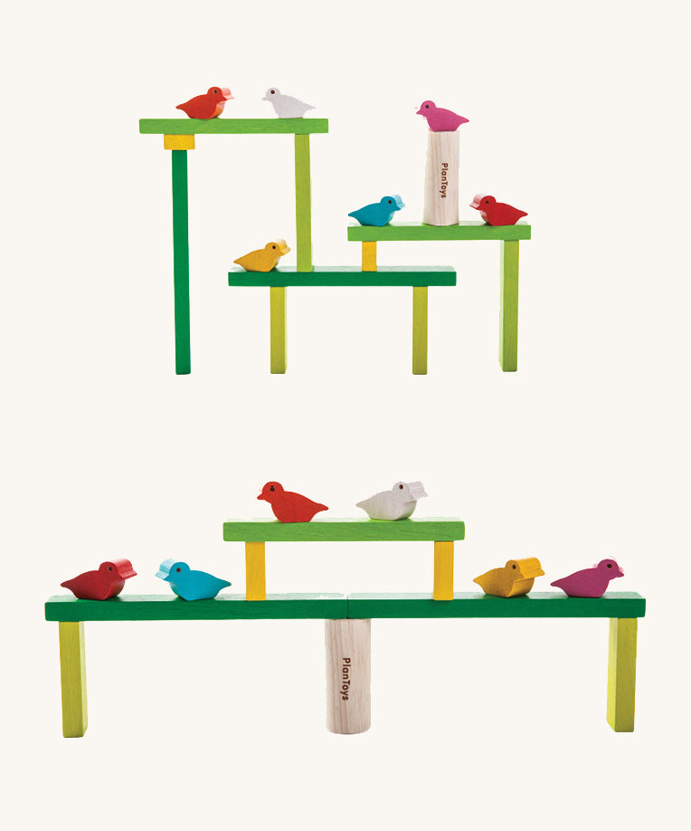 The PlanToys Balancing Tree stacked up in different ways. The stacks are platform like structures with the birds sitting at different points. 
