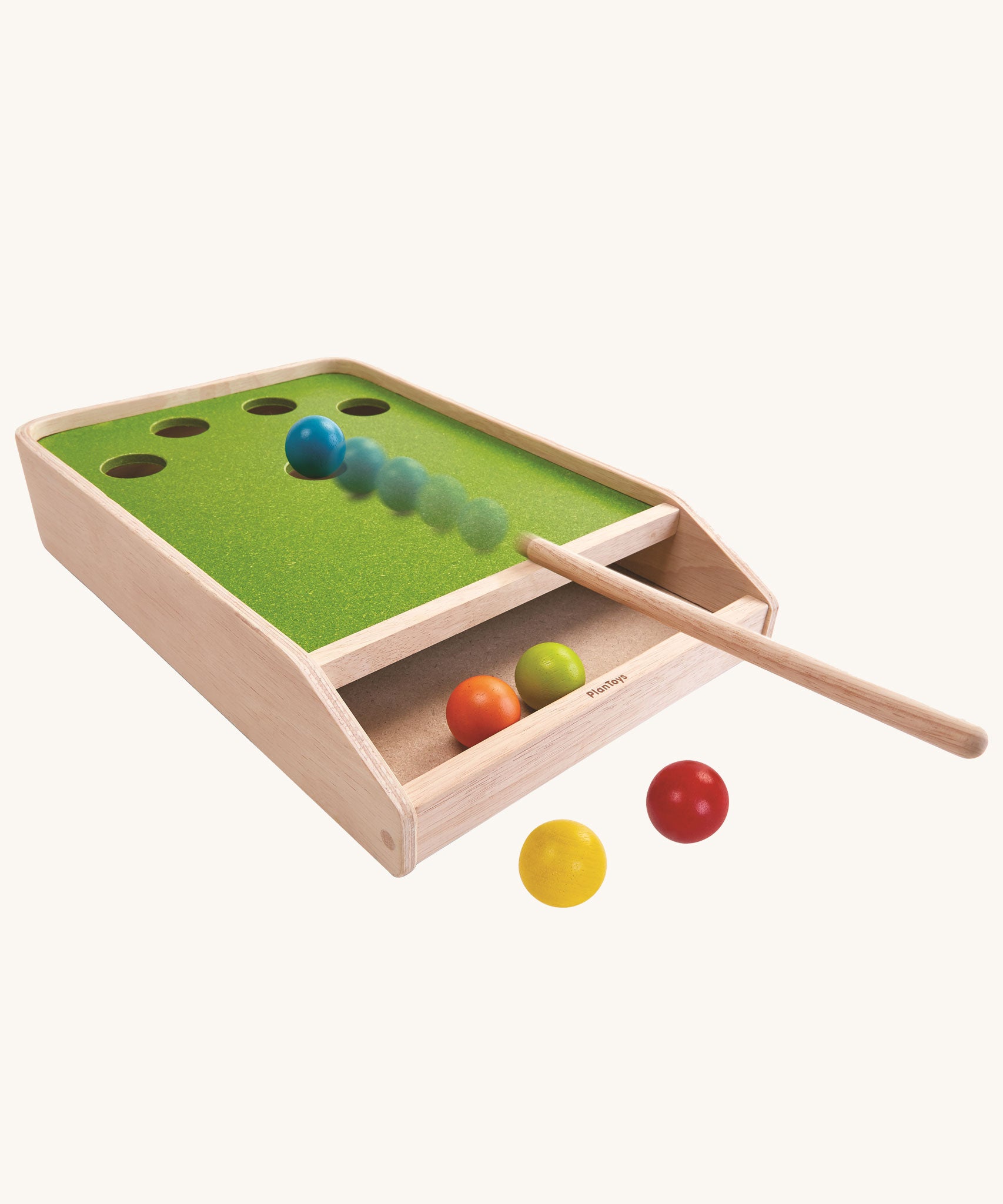 The PlanToys Ball Shoot Board Game on a plain background. Motion can be seen as the cue hits the yellow coloured ball. 