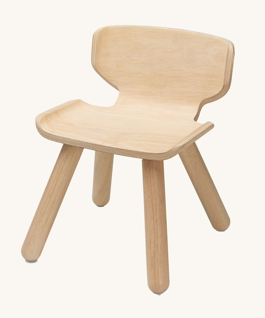 PlanToys wooden child's chair on a plain background.