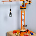 PlanToys PlanWorld Crane Set on a wooden shelf in front of a white wall. 