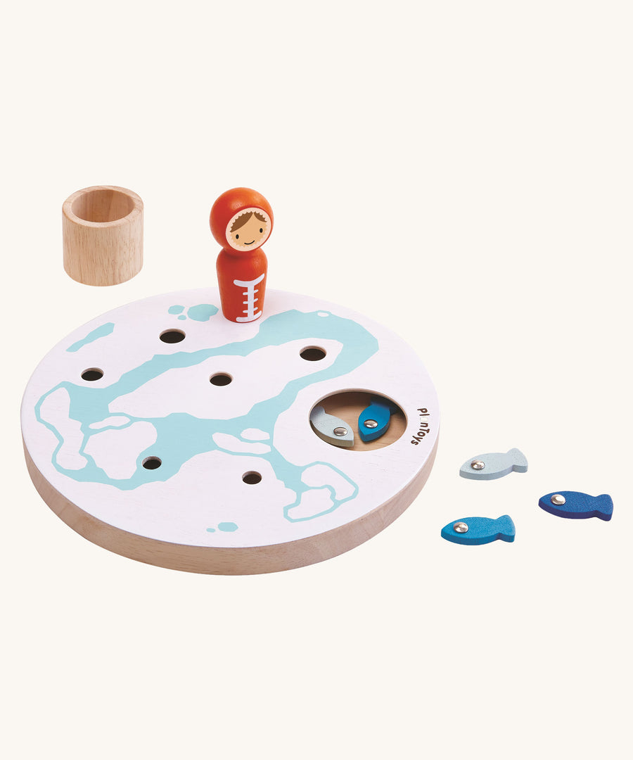 PlanToys Ice Fishing Game on a plain background. Some of the fish can be seen inside the base and some by the side of the base.