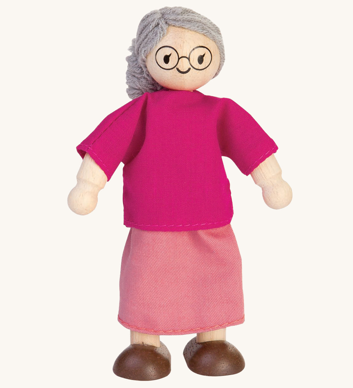 The PlanToys Grandmother Doll on a plain background. 
