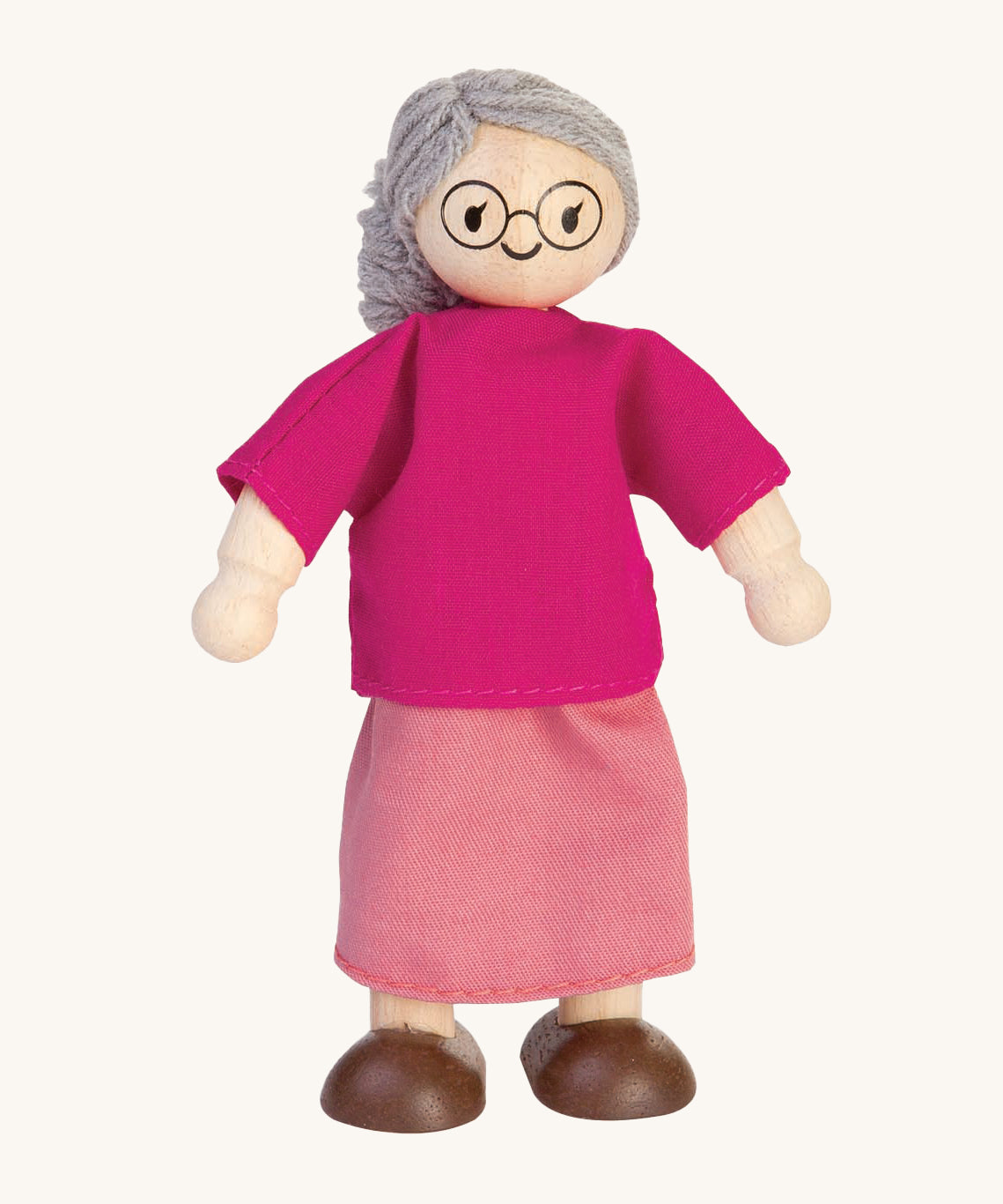 The PlanToys Grandmother Doll on a plain background. 
