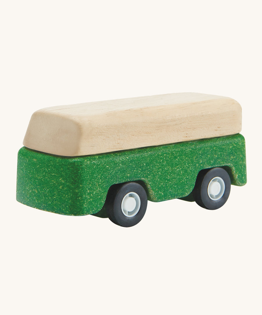 A PlanToys Green Bus on a plain background. 
