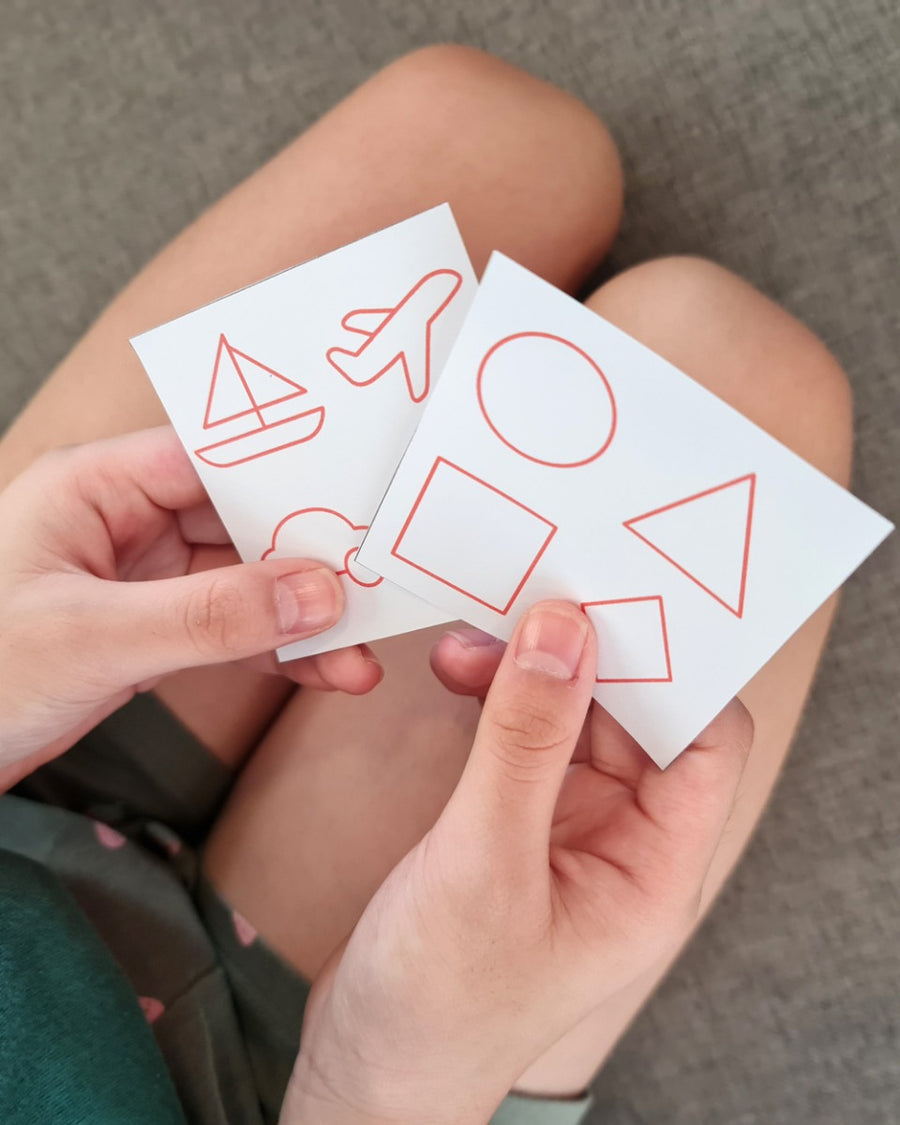 playing with the PlanToys sensory touch and guess game on a grey sofa