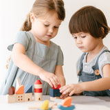 Two children playing with the PlanToys Wooden Marina Blocks, 