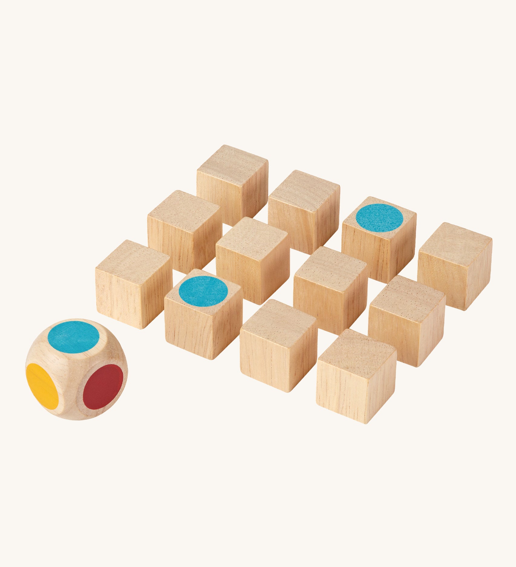 The PlanToys Mini Memo Game on a plain background. The cubes have all been turned to the black sides apart from two showing matching blue dots. 