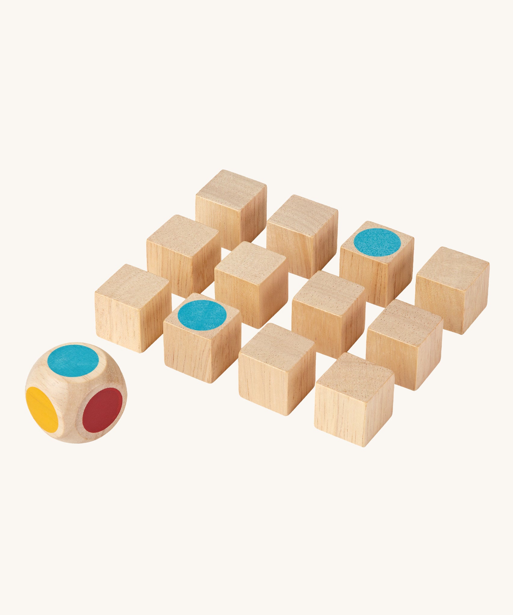 The PlanToys Mini Memo Game on a plain background. The cubes have all been turned to the black sides apart from two showing matching blue dots. 