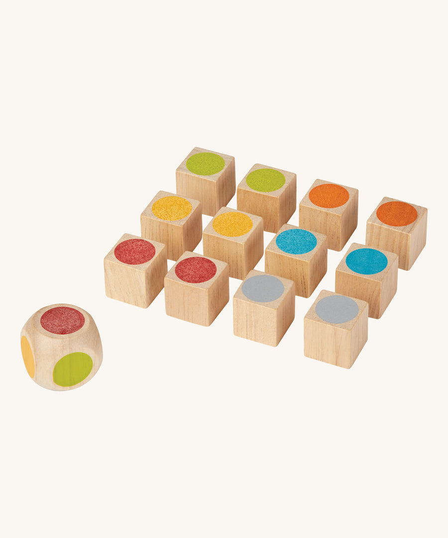 The PlanToys Mini Memo Game on a plain background. The pieces are all showing the coloured sides of the cubes. 
