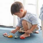 A child playing with the Plan Toys Fishing Game. 