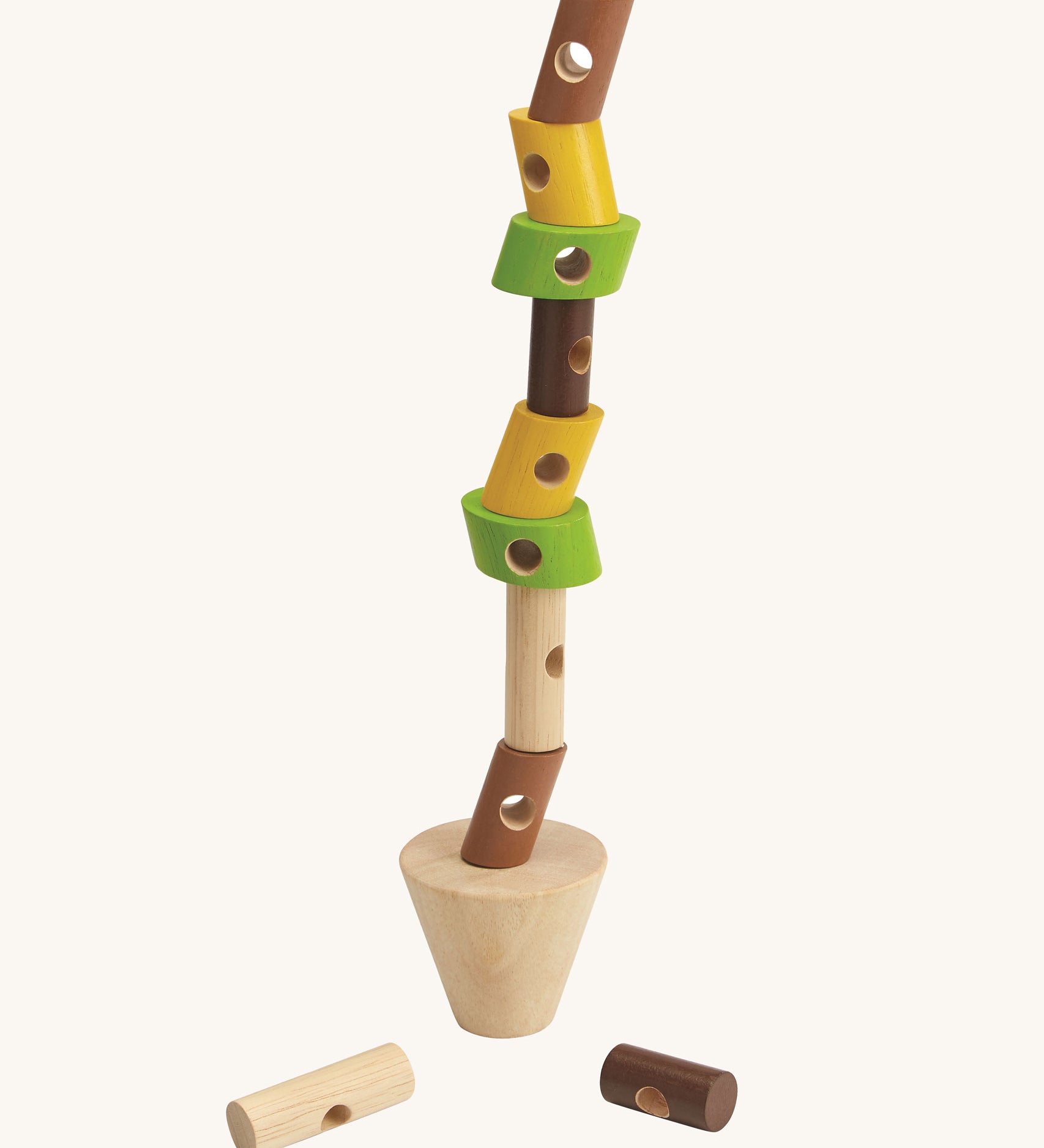 The PlanToys Stacking Logs Game on a plain background with the logs all stacked in a tall stack on the base piece. 