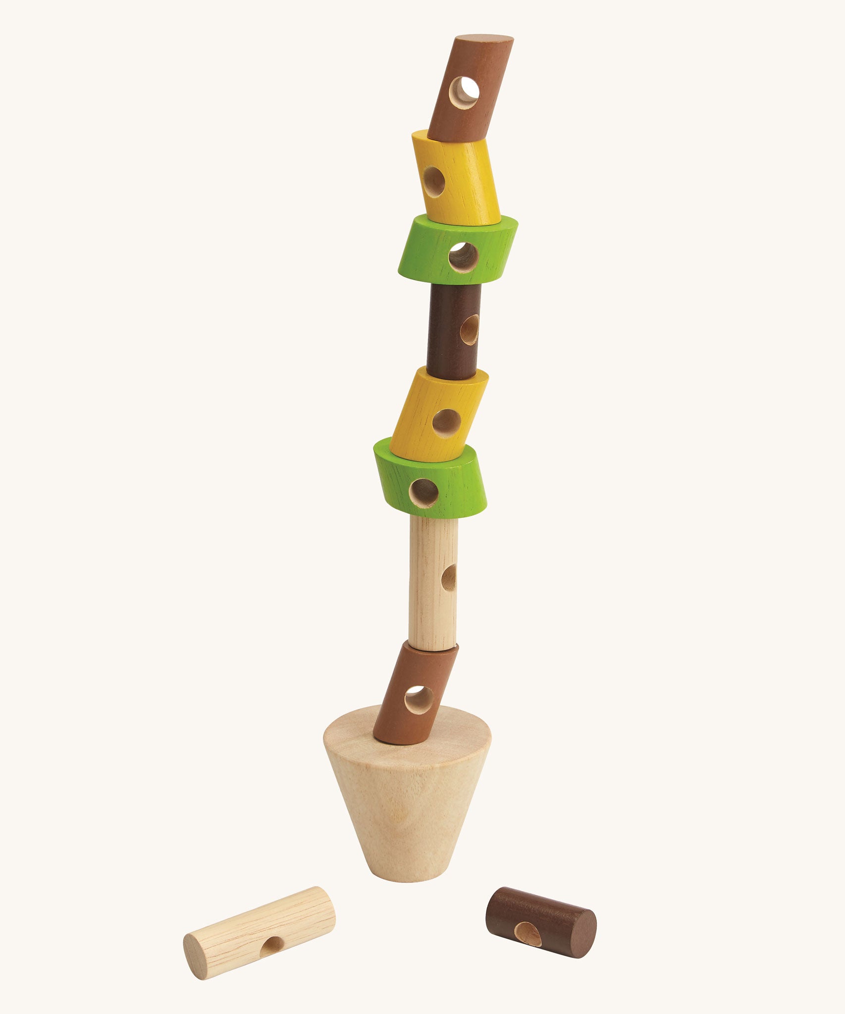 The PlanToys Stacking Logs Game on a plain background with the logs all stacked in a tall stack on the base piece. 