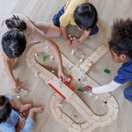 An overhead view of children playing with the PlanToys Road System.