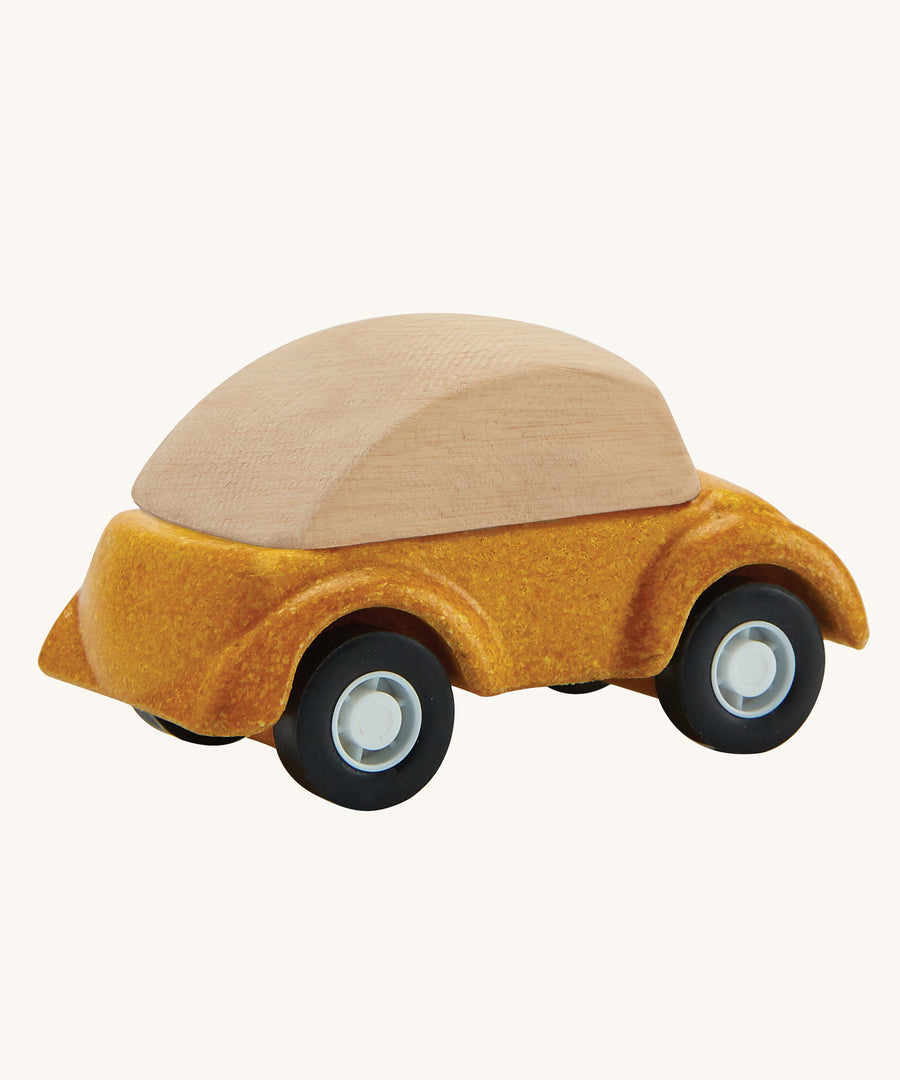 A view of the back of a PlanToys Yellow Car on a plain background. 