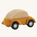 A view of the back of a PlanToys Yellow Car on a plain background. 