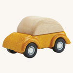 A PlanToys Yellow Car on a plain background. 
