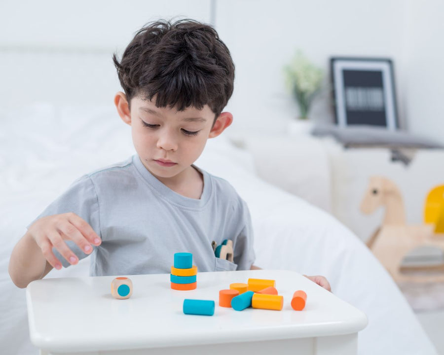 a series of colourful blocks and a dice to stack into a tower.