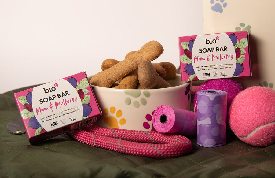 Bio-d natural plum and mulberry solid soap bar next to a dog bowl with biscuits