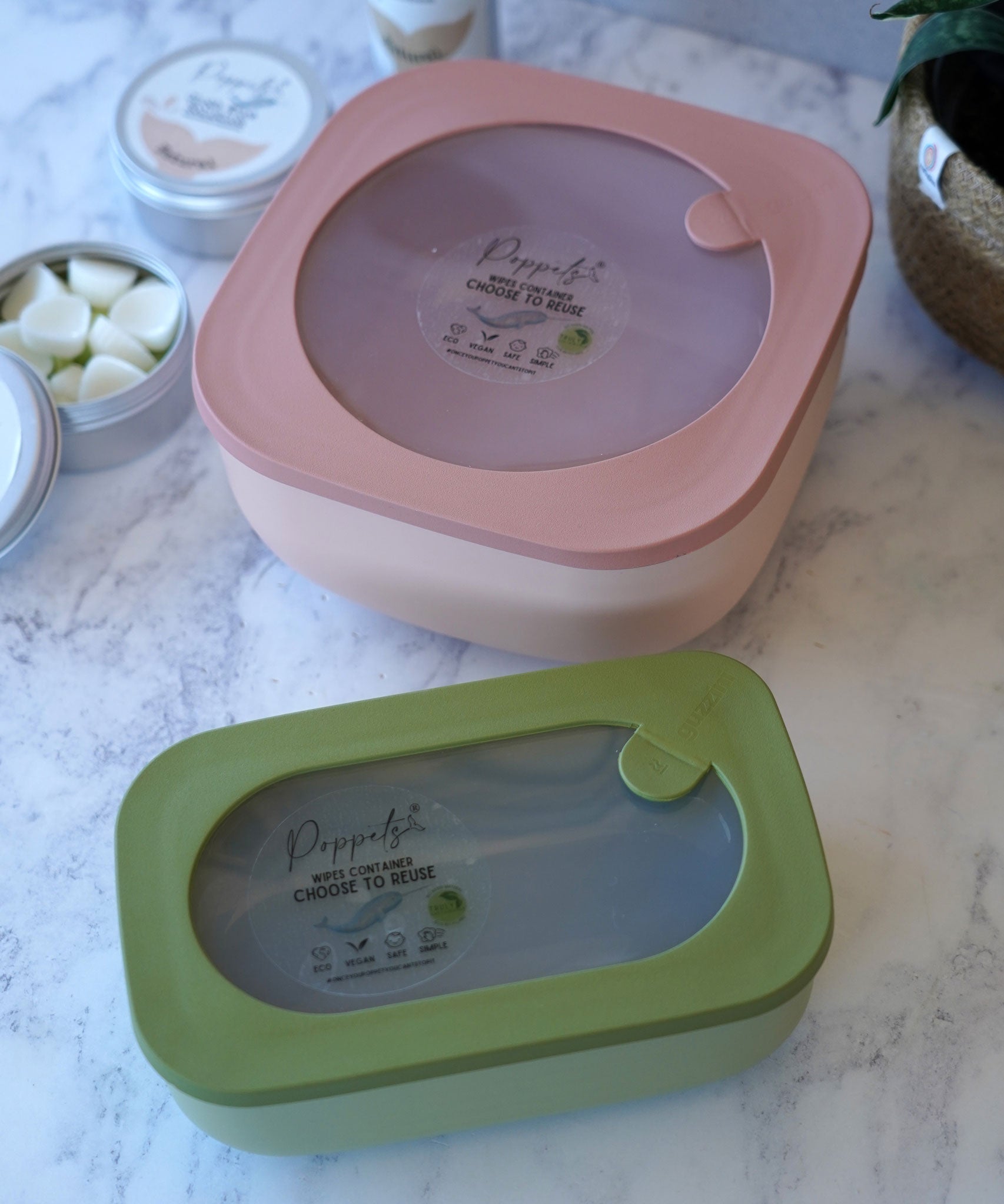 Two Poppets Reusable Baby Wipes Containers on a marble style surface. 