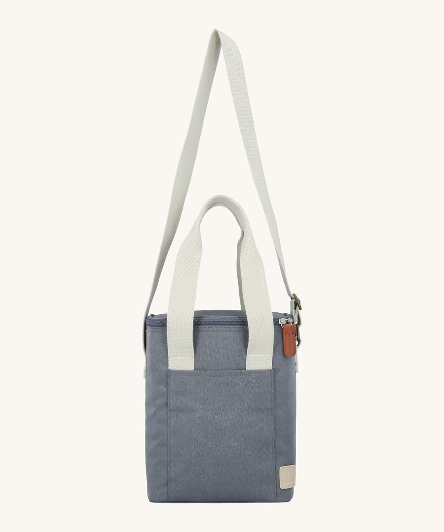 The extendable sholder strap on the Lola & Lykke Milk Cooler Bag is shown in an upwards position, along with the carry handles