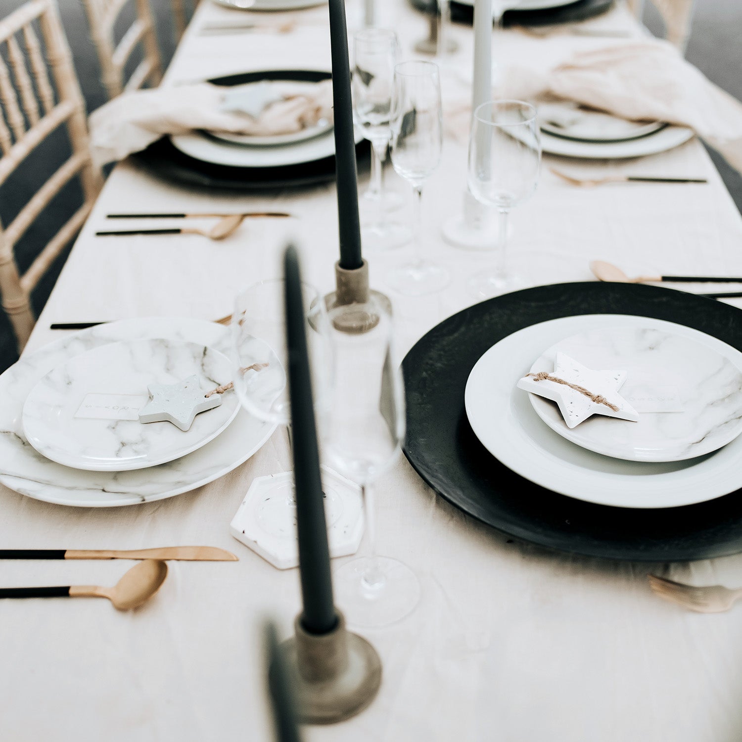 Rawr Grey Concrete Candlesticks arranged on a table set for lunch.