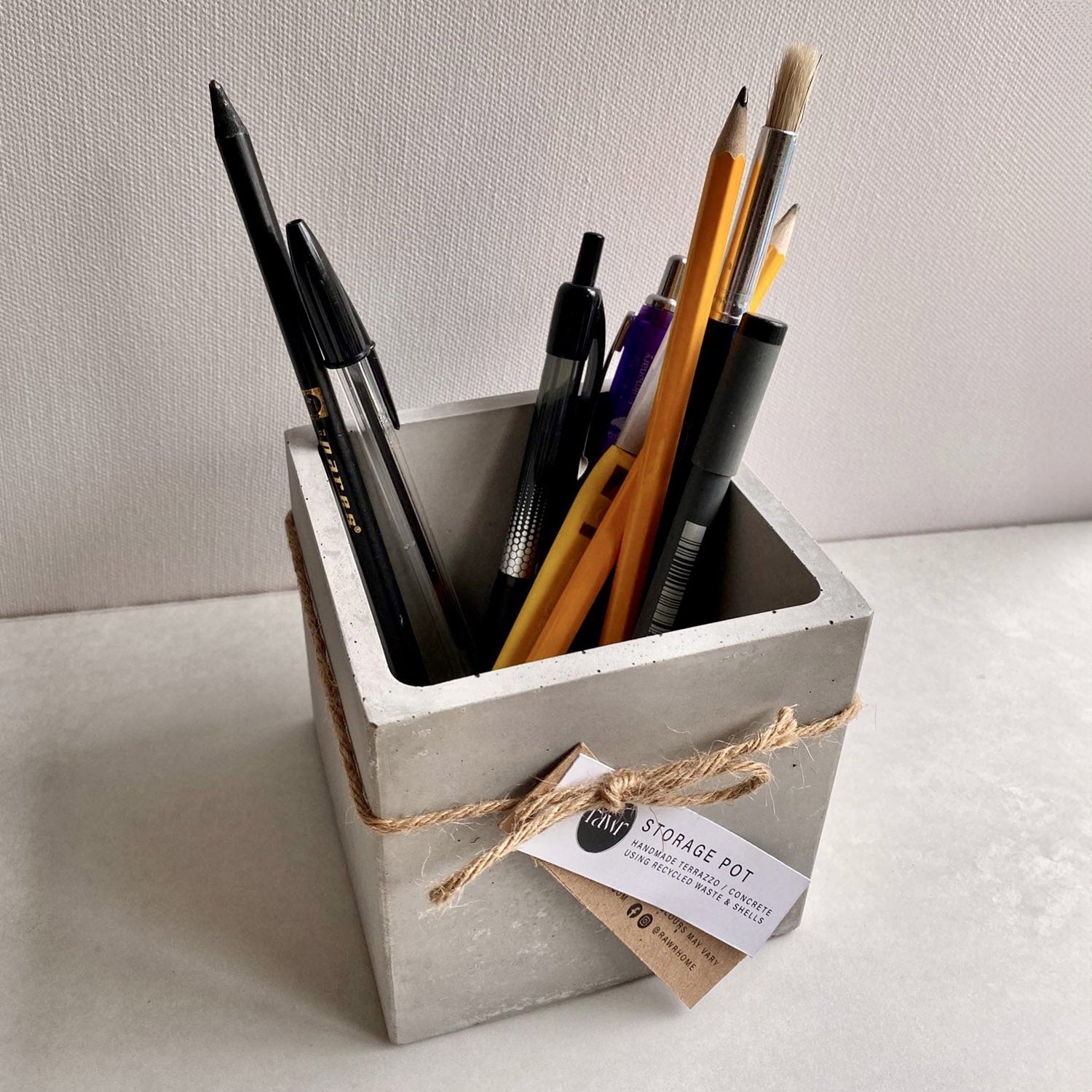 Rawr Grey Concrete Square Storage Pot contains pens