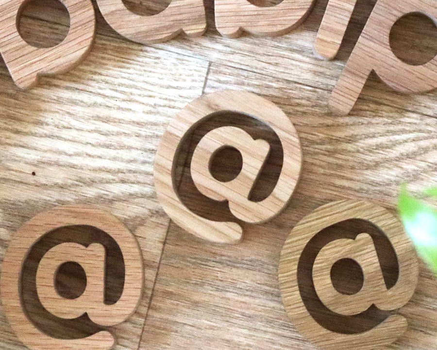 Numbers and Symbols laid out on a wooden floor spelling the word Babipur