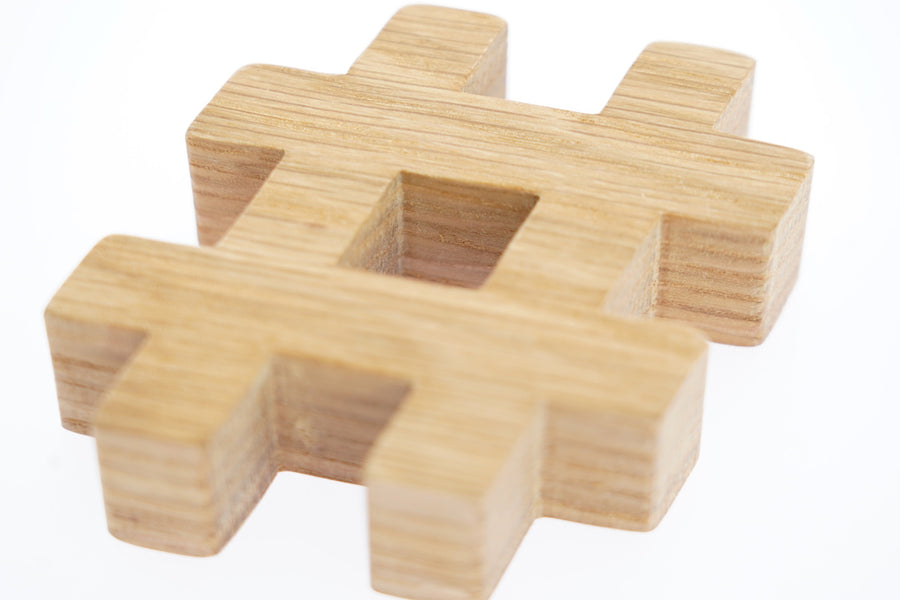 Close up of the Reel Wood eco-friendly hashtag symbol block on a white background