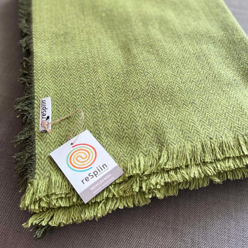 Close up of the recycled wool label on the Respiin natural recycled wool throw