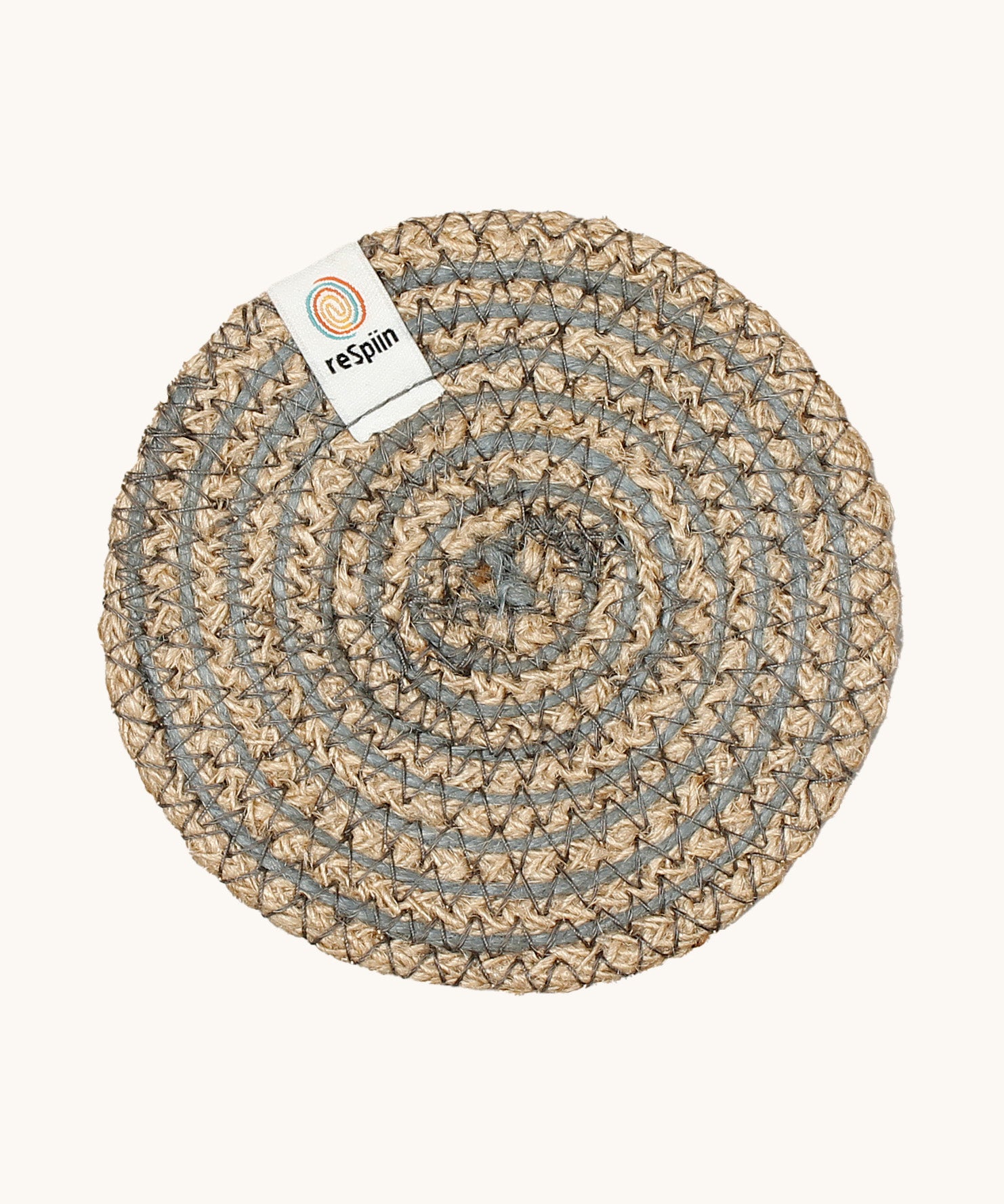 Respiin natural jute coaster in grey spiral on a cream background