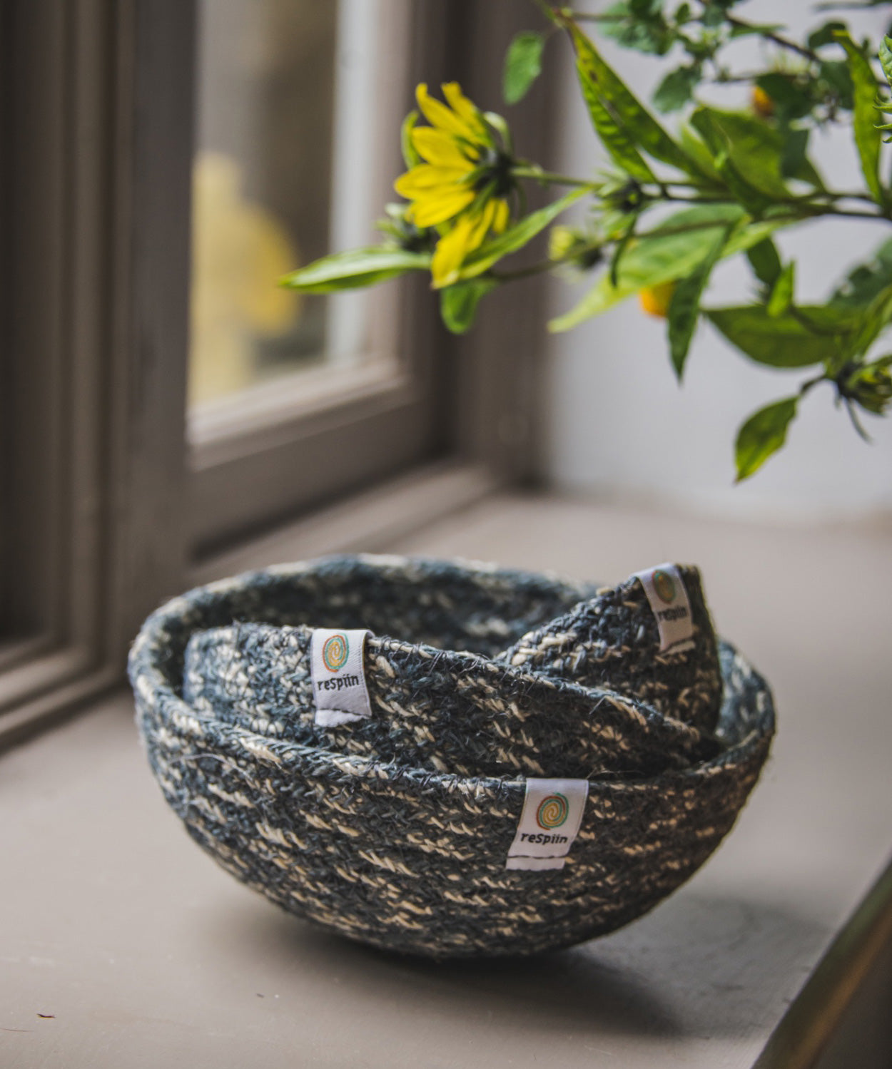 ReSpiin Jute Multicoloured Mini Bowl Set of 3 in the white and grey  colourway on a windowsill. 