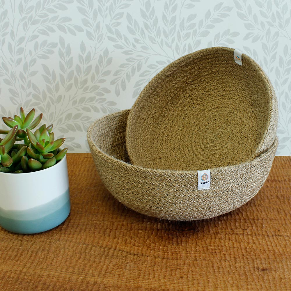 ReSpiin Jute Natural Medium & large woven Bowls with white respiin labels on a table with a tan sheet