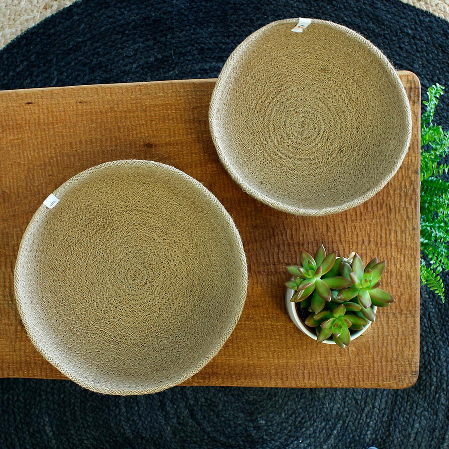 ReSpiin Jute Natural Medium & large woven Bowls with white respiin labels on a table with a tan sheet