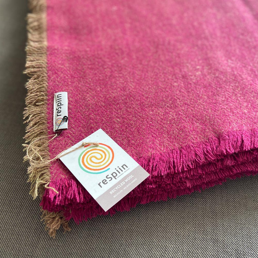 Close up of the recycled wool label on the Respiin purple throw blanket