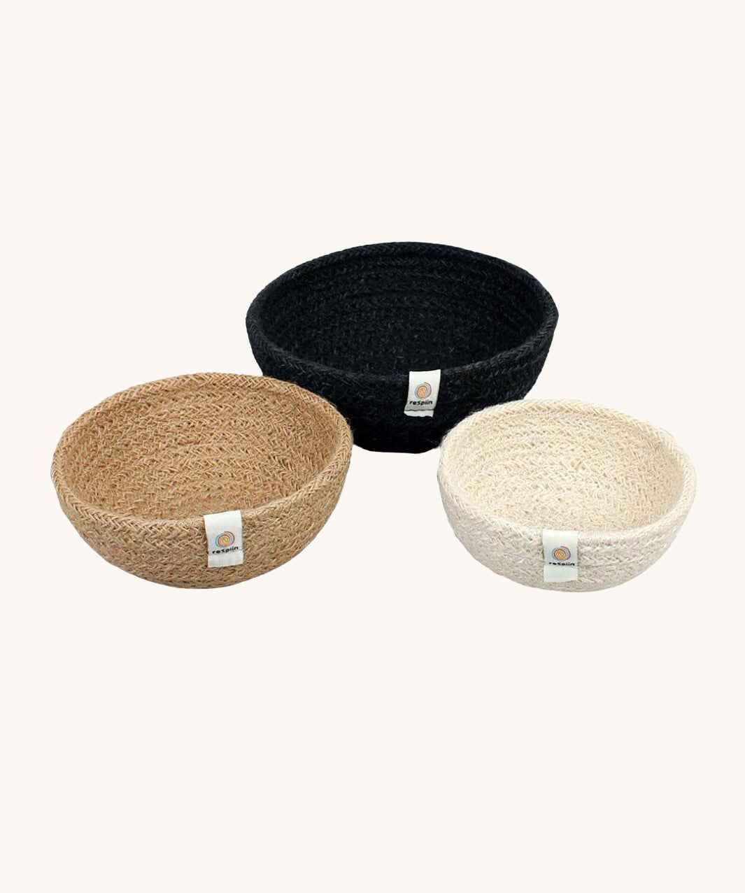 Respiin set of 3 natural mini bowls in natural, cream and black colour on a cream background.