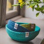 ReSpiin Jute Multicoloured Mini Bowl Set of 3 in the ocean colourway nestled inside each other placed on a window sill