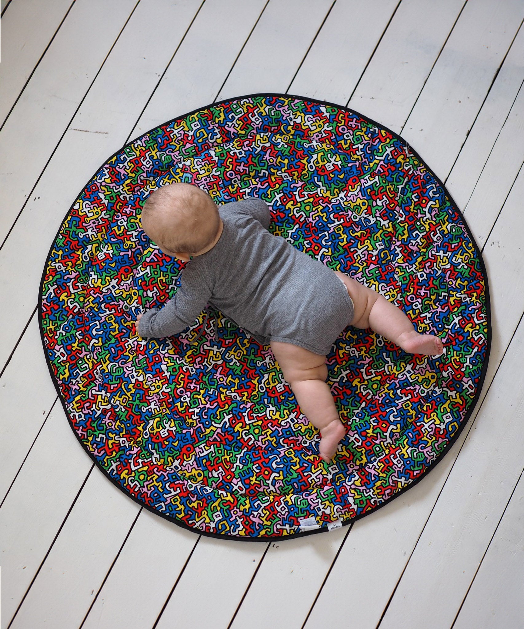 A closer look at the  'Baby' print on the Etta Loves X Keith Haring Reversible Organic Cotton Baby Play Mat