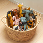 A collection of Roommate cotton ag dolls in a seagrass basket. 