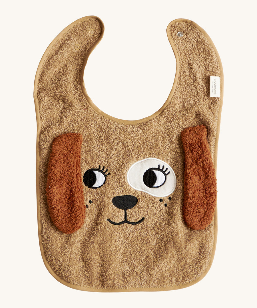 The Roommate Dog Baby Bib with an embroidered puppy face with floppy 3D ears. Cream background.