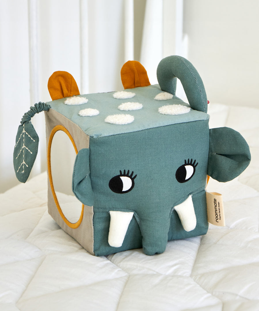 The Roommate Jungle animals soft Baby Activity Cube toy showing the side with the elephant face and the side with the mirror.